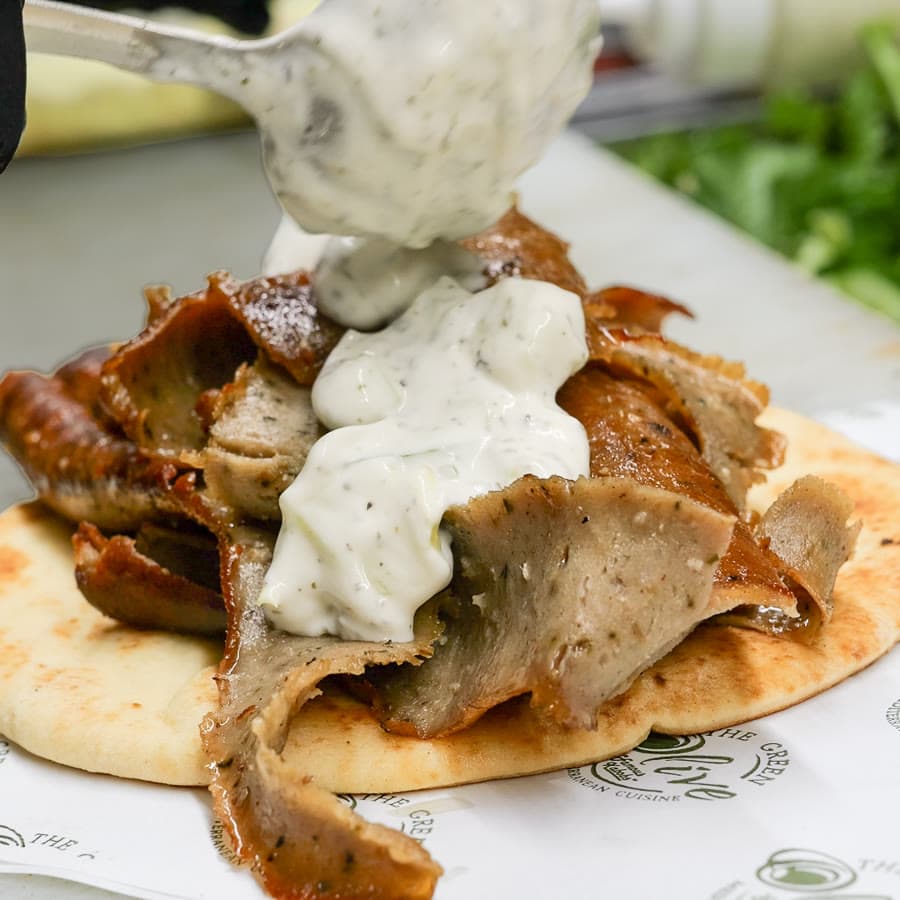A gyro plate with garlic sauce