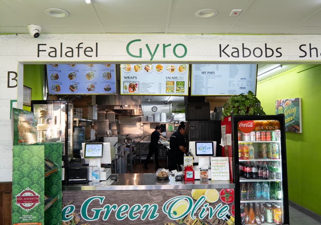 The counter and menu board at The Green Olive