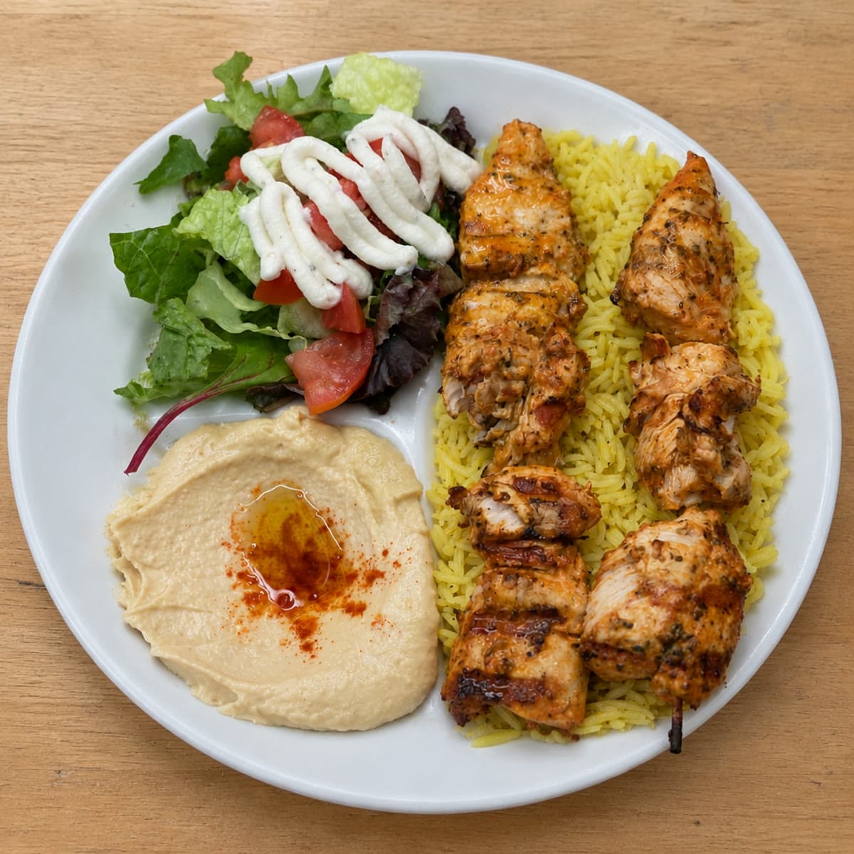 A Green Olive catering platter of shawarma, kabobs and rice